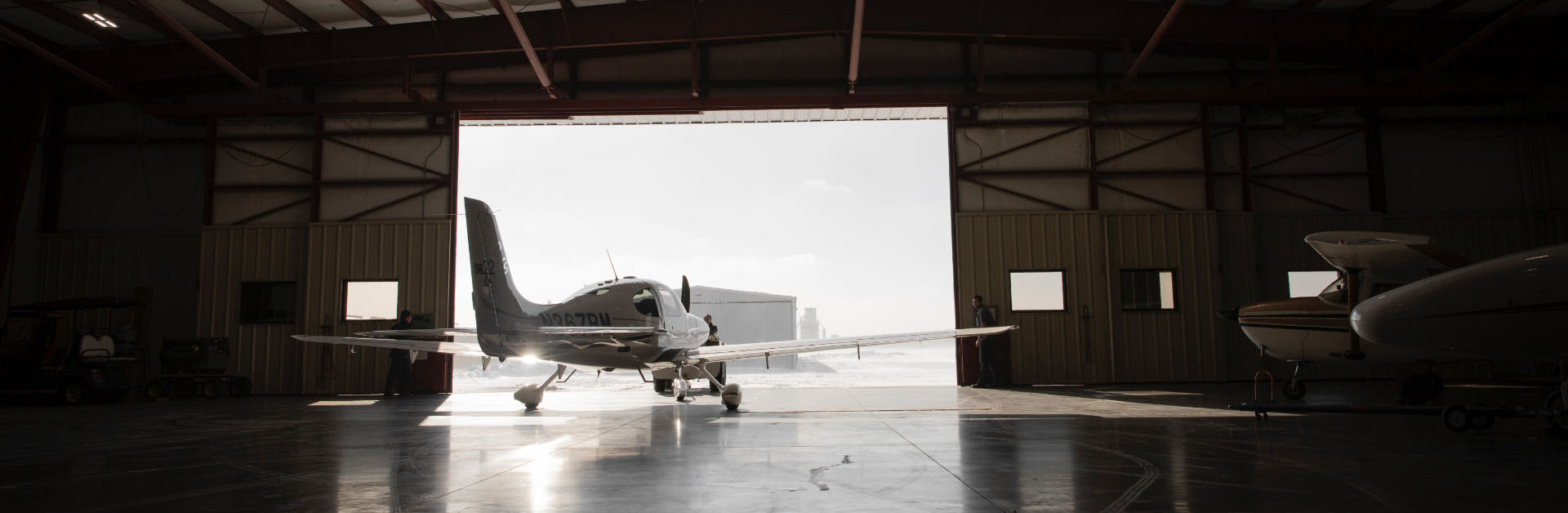 Plane inside with hangar doors open